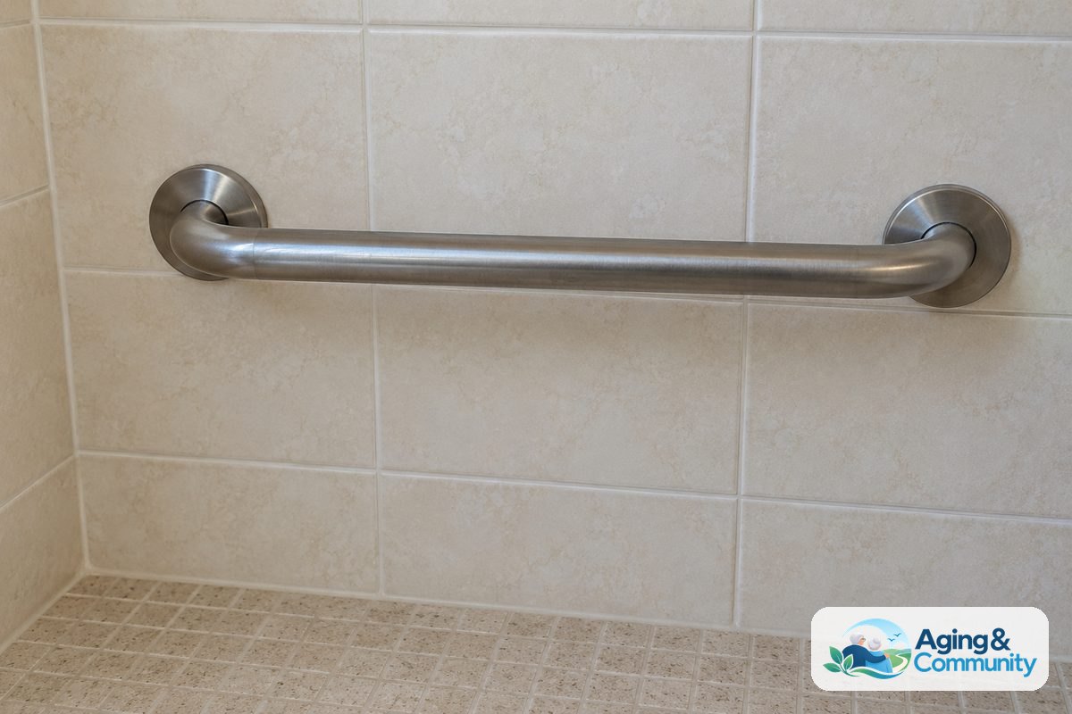 A brushed stainless steel grab bar is mounted horizontally on a tiled shower wall above an uncluttered shower floor.